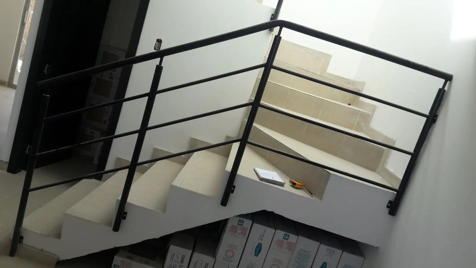 Pasamanos de hierro negro en escalera interior de vivienda