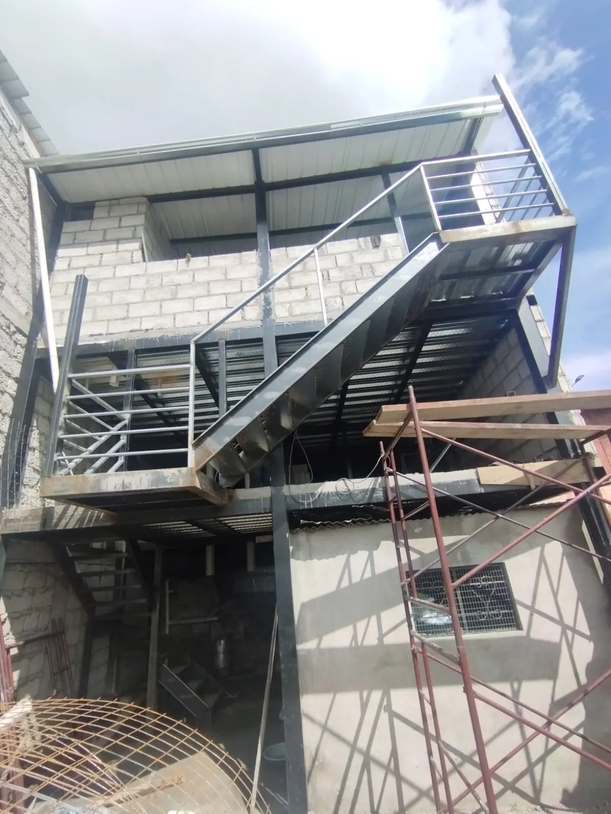 Gradas metálicas exteriores con pasamanos en edificio